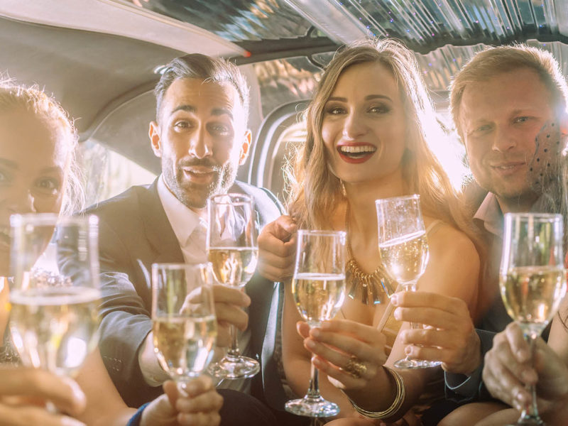 Drinking champagne inside a limousine